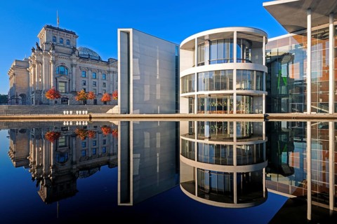 Reichstag and Paul-Loebe-Haus reflected in the Spree at sunrise