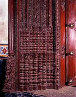 Richly carved wooden door of an old house portal in kanadukathan