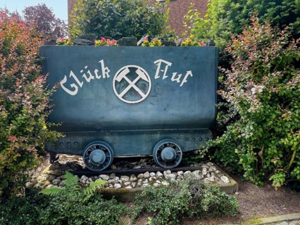 Disused colliery lorry with miner's greeting Glueck Auf stands in front garden in the Ruhr area
