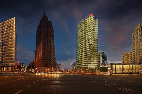 Building of the Daimler Benz area on the left and Bahntower and Beisheim-Center on the right in the evening at Potsdamer Platz