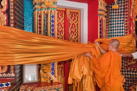 Monk attaches Songkran temple decoration