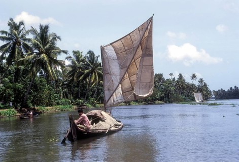 A boat man carrying sand on a dhow