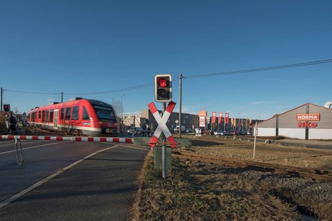 Passing train at a level crossing with barriers