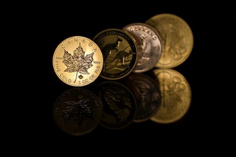Four mirrored gold coins