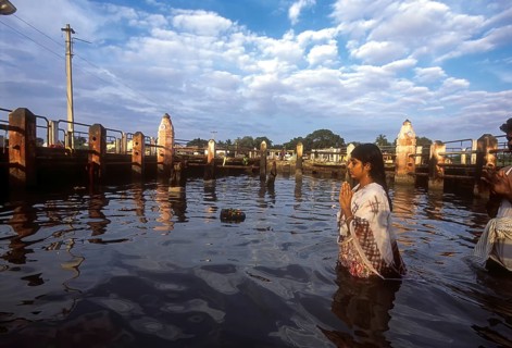 A girl worshipping Navagraha idols