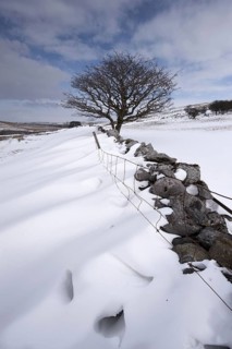 View of snow drifts behind a dry stone wall