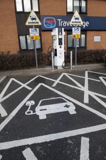 Reserved parking space at electric car charging point at motorway service station
