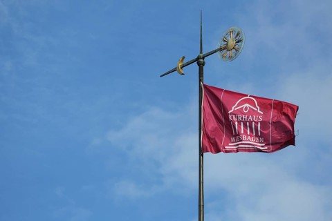 Weather vane with flag on the roof of the spa hotel in Wiesbaden