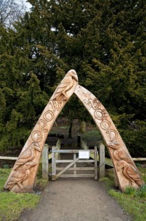 Carved wooden arch at entrance to woodland