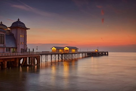 View of Victorian pier in seaside town at sunrise