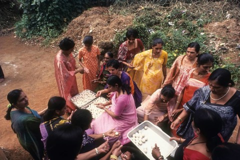 Kodava women making rice ball Kadamputtu