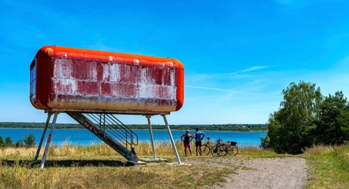Red container at the lake that serves as a viewing platform
