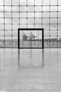 View through modern glass facade with large door onto the harbour