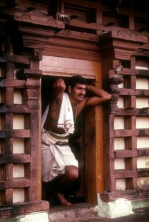 Priest standing at Thirunakkara Siva Temple in Kottayam
