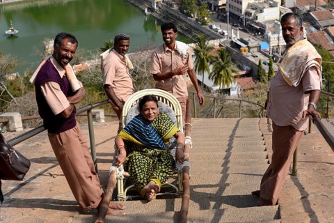 Porter with tourist on the road leading to the Gomateshwara statue