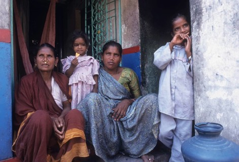 Fisher women sitting infront of the house