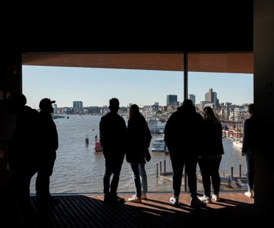 Visitors standing at the window of the public viewing platform