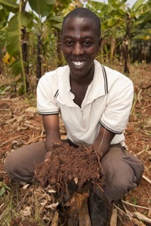 Farmer with fertile soil mixed with compost