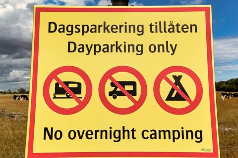 Yellow sign with inscription Parking only during the day
