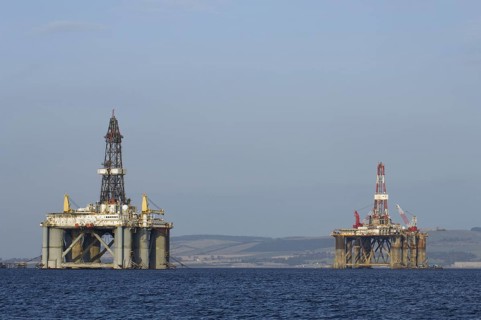 Oil rigs moored in sea near coast