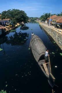 Men Pushing Kettuvallam in the Backwaters of Alappuzha