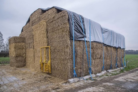 Covered straw stack with large bales