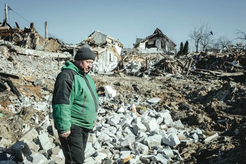 Serhiy Melnyk stands on the ruins of his house in the residential district of Bohunia
