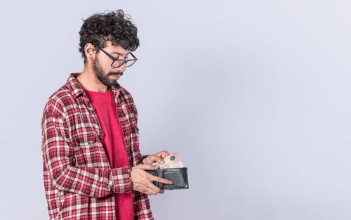 Portrait of man taking money out of his wallet