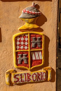 Coat of arms and lettering of San Liborio on house wall