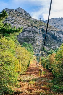 Ropeway Cabinovia Monte Capanne with open gondola Ropeway gondola standing gondola on mountain Monte Capanne
