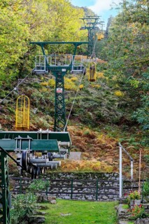 Cable car and cable car masts of Cabinovia Monte Capanne with open gondola cable car gondola standing gondola on mountain Monte Capanne