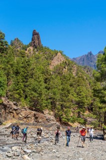 Hikers in front of the landmark rock needle Roque Idafe