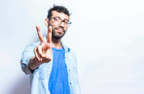 People finger counting the number two on an isolated background. Person hand counting number two. Handsome guy hand showing number two