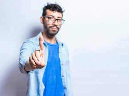 People finger counting the number one on an isolated background. Person hand counting number one