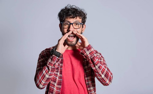 Person announcing and shouting with hands. Attractive man announcing and shouting with hands