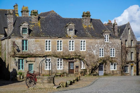 Village square with old horse-drawn cart and fountain