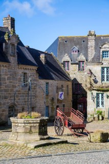 Village square with old horse-drawn cart and fountain