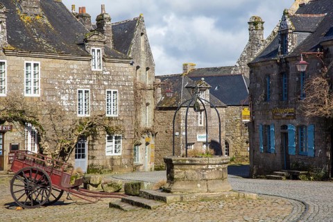 Village square with old horse-drawn cart and fountain