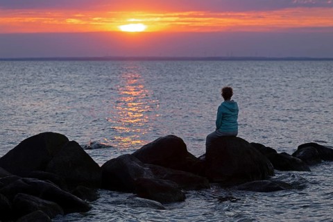 Woman sitting on stones