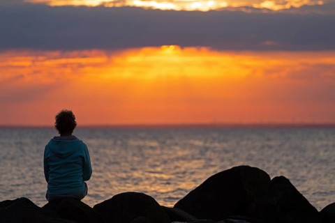 Woman sitting on stones