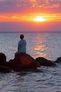 Woman sitting on stones