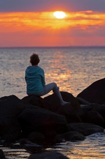 Woman sitting on stones