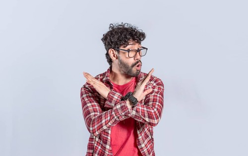 Handsome man crossing arms in rejection