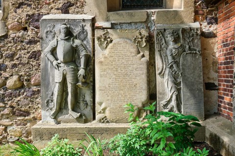 Figure gravestone and sandstone epitaph with angel figure
