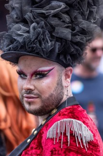 Made-up transvestite with hat and nose piercing takes part in CSD parade