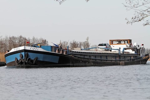 Fully loaded Dutch cargo ship Fivel on the river Peene