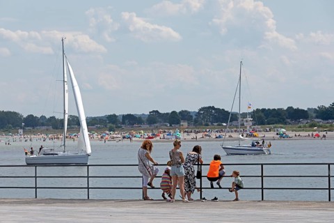 Family looking across the river Trave to the beach of Priwall