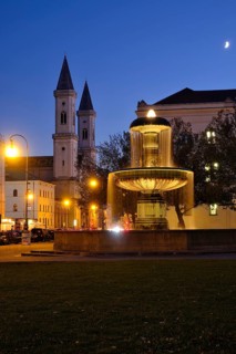 Illuminated fountain of the University and Church of St. Ludwig