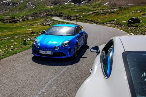 Sports car Renault Alpine coming towards Porsche GT3 on mountain road