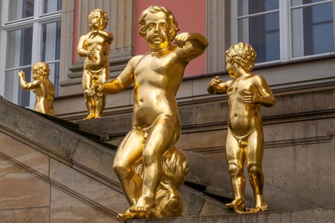 Golden figures on angel's staircase in front of Potsdam City Palace